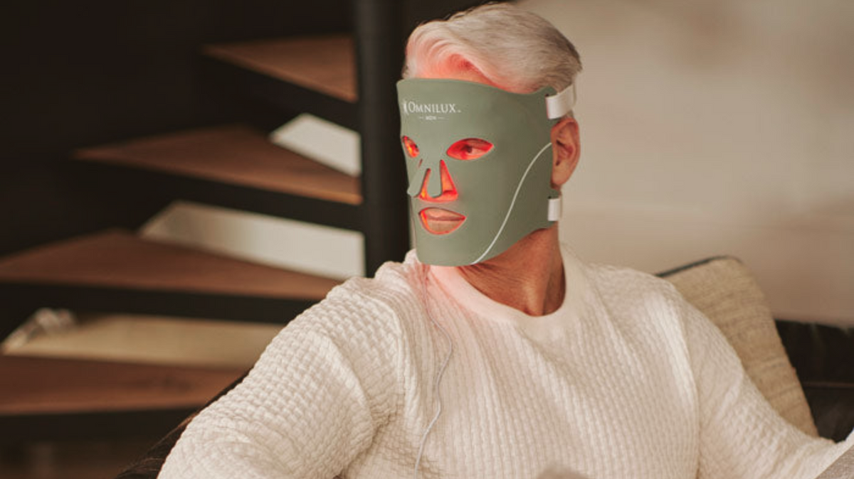 Man wearing an LED red light therapy face mask