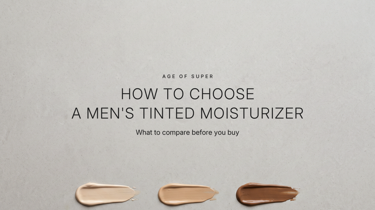 Centered text "How to choose a men's tinted moisturizer" with the line "What to compare before you buy" on a warm gray stone surface, above three small swatches of tinted cream in light, medium, and dark tones
