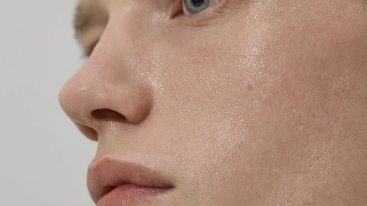 Close-up side profile of a man's face with natural-looking, even skin