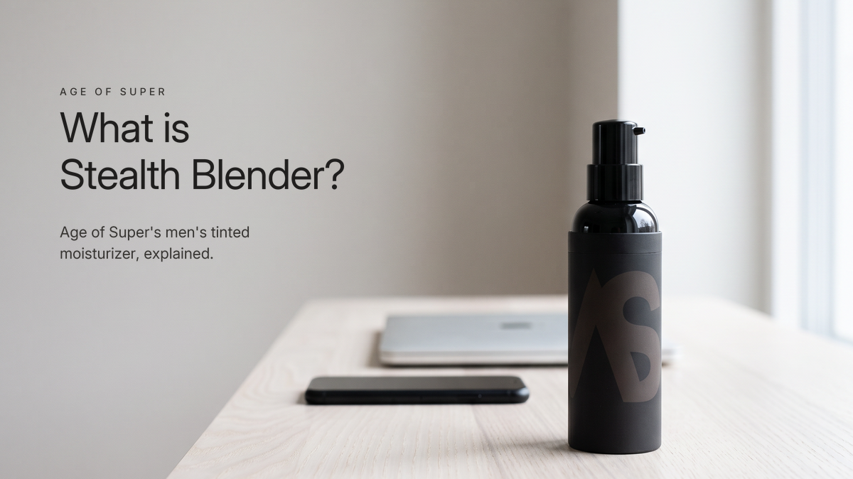 A black Stealth Blender pump bottle standing on a pale ash desk in cool window light, a closed silver laptop and a face-down smartphone soft behind it, beside the title "What is Stealth Blender?"