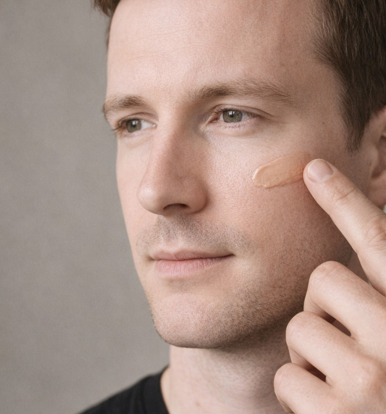 Man with light skin blending Stealth Blender into his cheek