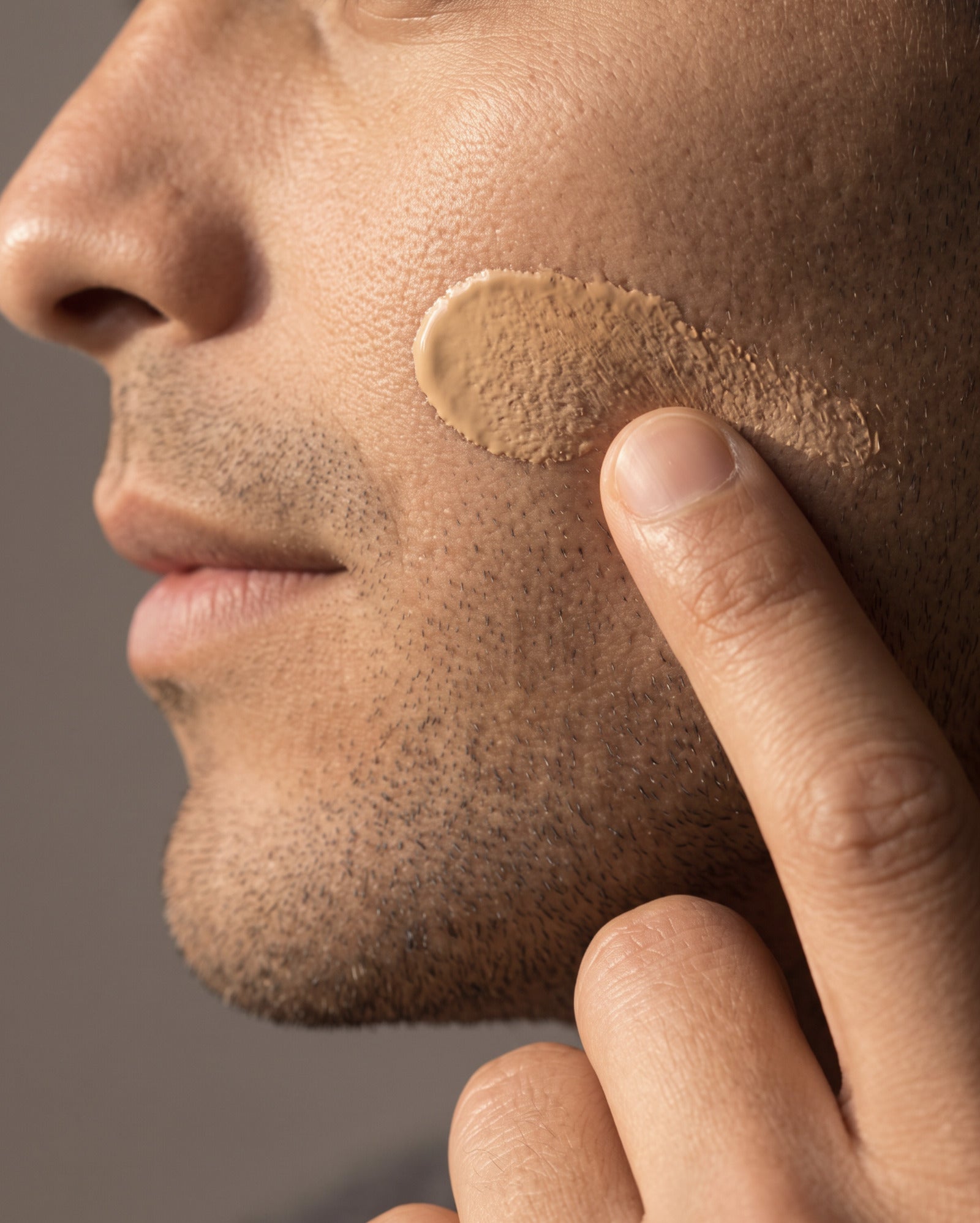 Close-up of a man's cheek with a swipe of Stealth Blender tinted moisturizer
