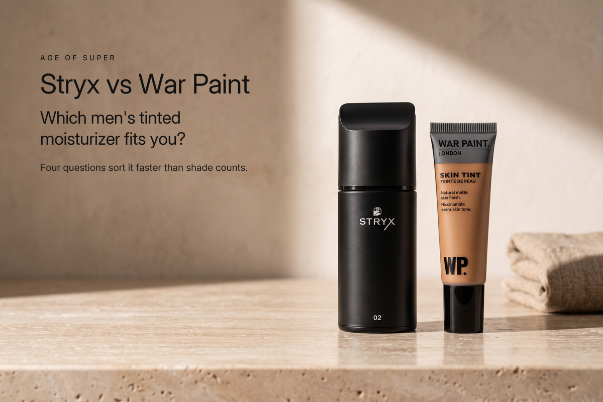 A matte black Stryx Product 02 Tinted Moisturizer bottle beside a War Paint for Men Skin Tint tube on a honed travertine stone counter in morning sunlight, beside the title "Stryx vs War Paint, which men's tinted moisturizer fits you?"