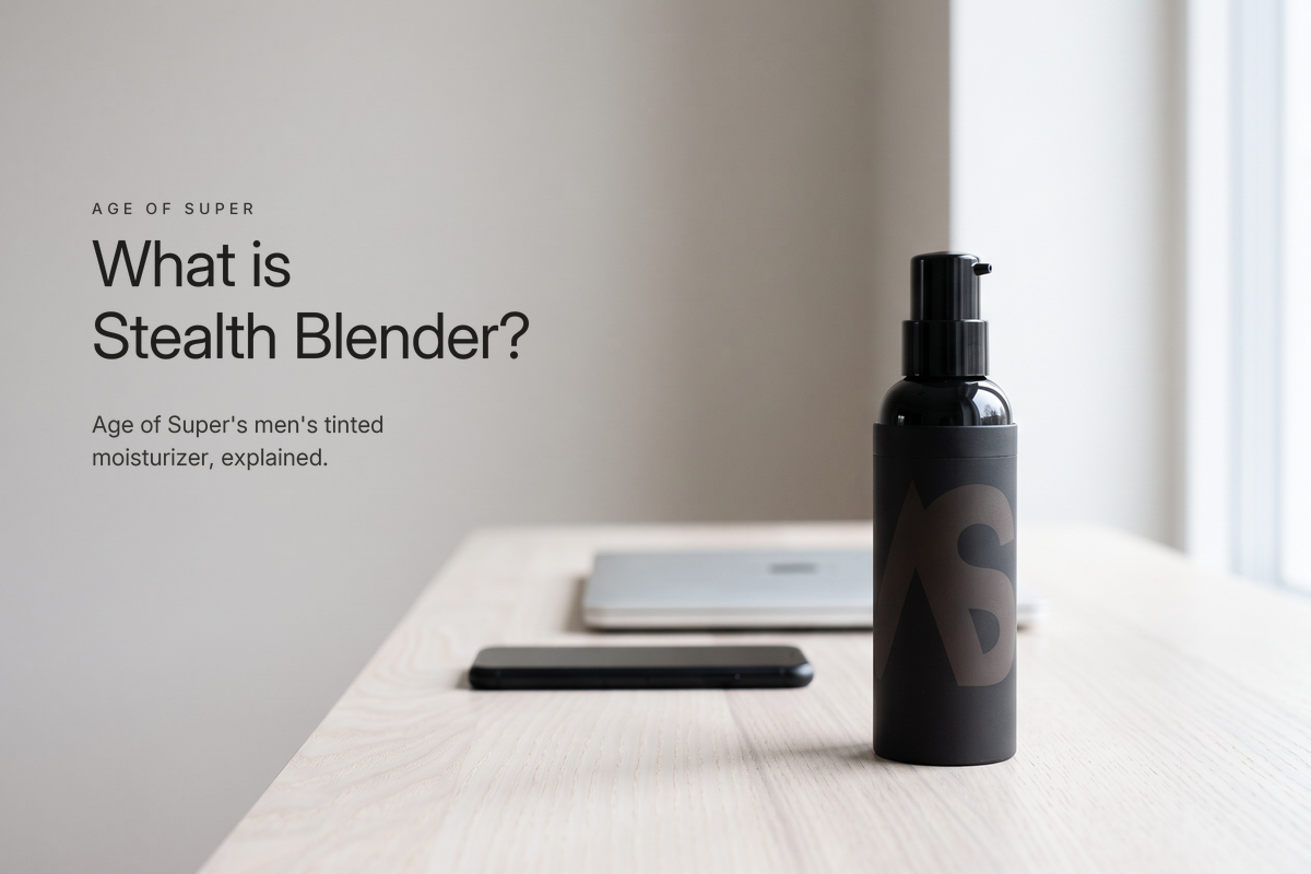 A black Stealth Blender pump bottle standing on a pale ash desk in cool window light, a closed silver laptop and a face-down smartphone soft behind it, beside the title "What is Stealth Blender?"