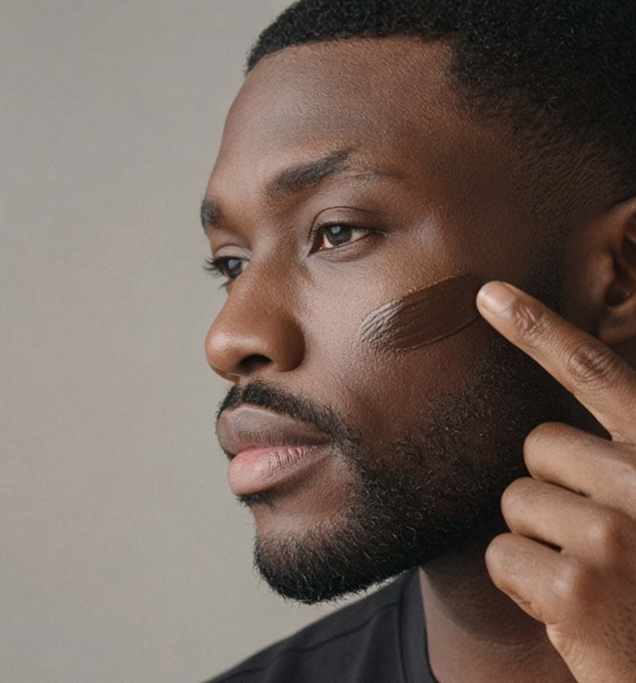 Man with dark skin blending Stealth Blender into his cheek