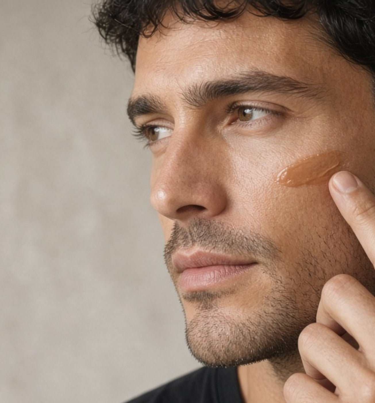 Man with medium skin blending Stealth Blender into his cheek